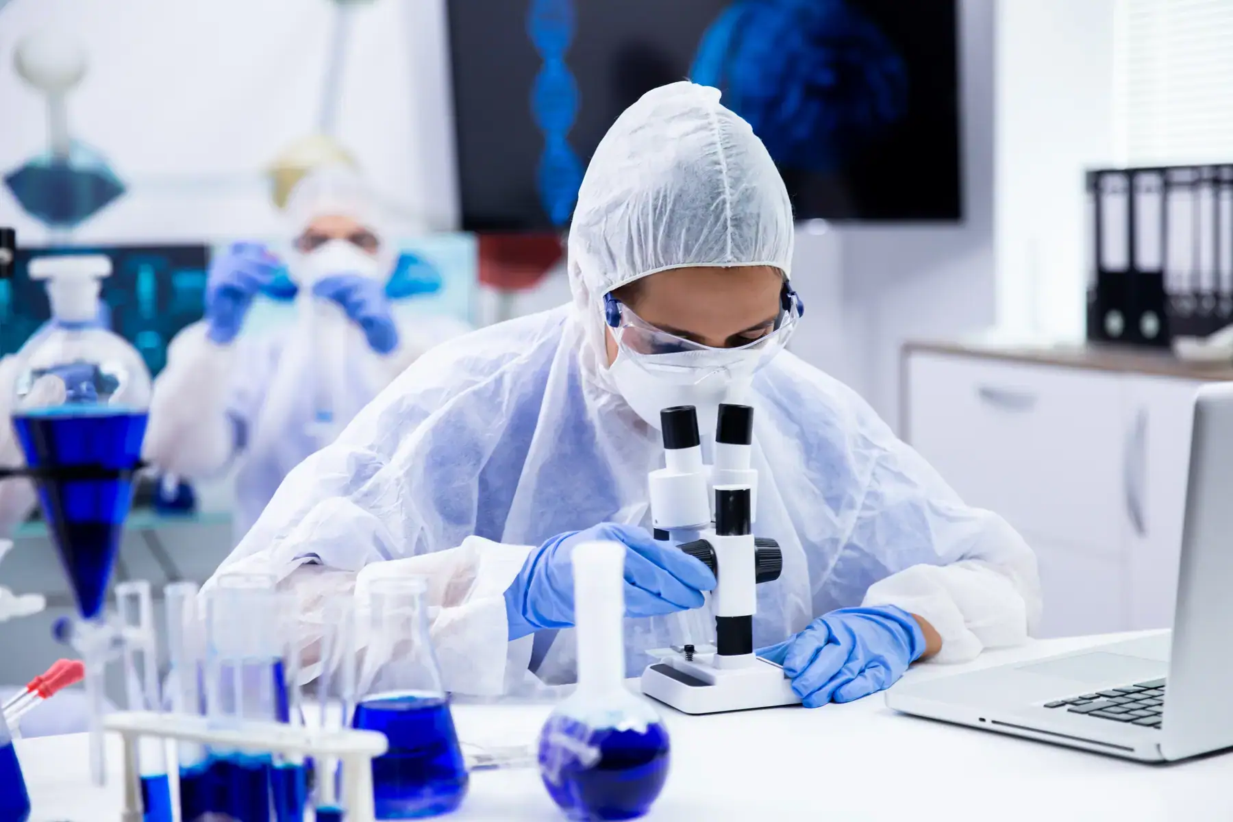 Dow Health Research scientist examining a sample through a microscope in the laboratory